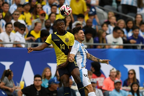 Alan Minda battles Gonzalo Montiel for a header